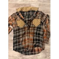 Rust charcoal and gray plaid flannel shirt with contrasting tan patterned chest pockets and collar