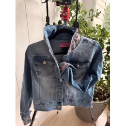 Front view of medium light-wash denim jacket with gray and pink bee-patterned collar and cuff
