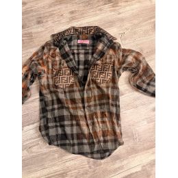 Rust charcoal and gray plaid button down flannel with brown geometric patterned chest pockets and collar