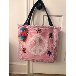 Pink bandana tote with beaded peace sign, colorful dancing bear patches, black shoulder straps and multicolor tassel