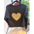 Back of black reworked jacket with large beige patterned heart applique