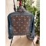 Back view of medium light-wash denim jacket with patterned panel and pink bee motifs