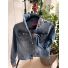 Front view of medium light-wash denim jacket with gray and pink bee-patterned collar and cuff