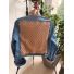 Back of medium blue denim jacket with large sand colored repeating pattern textile panel